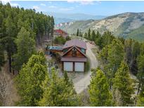 Stunning mountain home with a two-car garage and deck overlooking a breathtaking view at 197 Sawmill Ln, Idaho Springs, CO 80452