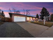 Charming brick ranch-style home with an attached garage and a spacious front yard at 3565 S Holly St, Denver, CO 80237