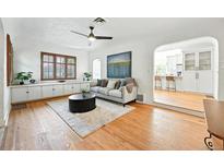 Bright living room features hardwood floors, large windows, and stylish decor with a comfortable seating area at 1731 Locust St, Denver, CO 80220