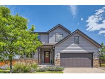 Charming two-story home featuring a well-maintained yard and inviting front entrance at 2150 Wagon Way, Louisville, CO 80027