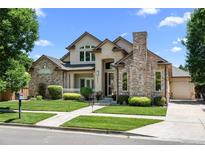 Beautiful two-story home featuring a well-maintained lawn and brick accents at 222 S Olive St, Denver, CO 80230