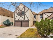 Charming Tudor-style townhome featuring a two-car garage and brick and timber accents at 7250 Eastmoor Dr # 119, Denver, CO 80237