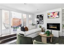 Bright living room with sliding doors to patio, modern fireplace, and stylish decor at 3635 Osage St, Denver, CO 80211