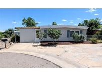 Charming single-story home featuring well-maintained landscaping and a concrete driveway at 2032 Tulane St, Denver, CO 80260