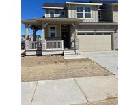 Two-story home featuring stone accents, a covered porch, and an attached two-car garage at 6731 Arbor E Blvd, Thornton, CO 80602