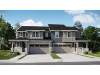 Charming paired home featuring a stone facade, covered entry, and two-car garage at 6731 Arbor E Blvd, Thornton, CO 80602