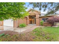 Charming home featuring a covered entrance and well-maintained front yard landscaping at 20401 High Pines Dr, Monument, CO 80132