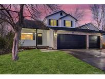 Two-story house with a landscaped yard, two-car garage, and updated exterior at 2221 Mattive Pl, Brighton, CO 80601