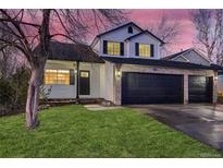 Two-story house with a two-car garage and landscaped lawn at 2221 Mattive Pl, Brighton, CO 80601