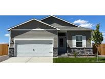 Charming single-Gathering home featuring a two-car garage, stone accents, and manicured lawn at 2225 Alyssa St, Fort Lupton, CO 80621