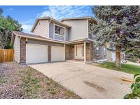Inviting two-story home featuring a brick facade and a spacious two-car garage for modern living at 18751 E Mexico Ave, Aurora, CO 80017