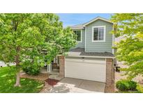 Charming two-story home featuring a well-maintained lawn and attached garage at 10571 Garfield St, Thornton, CO 80233