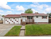 Charming single-story home with a cozy front porch and well-maintained lawn at 6327 Fenton St, Arvada, CO 80003