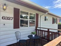 Cozy front porch features a small table and chairs, perfect for enjoying the outdoors at 6327 Fenton St, Arvada, CO 80003