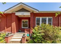 Charming brick home featuring a cozy front porch and landscaped entrance at 2023 E 20Th Ave, Denver, CO 80205