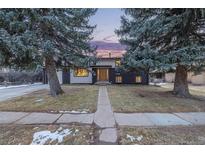 Ranch style home with mature landscaping and a paved walkway at 3600 E Orchard Rd, Centennial, CO 80121