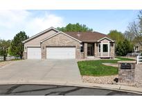Charming single-Gathering home featuring a well-manicured lawn and a three-car garage at 14447 Inca Ct, Westminster, CO 80023