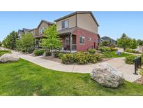Charming two-story home with a welcoming front porch and beautiful landscaping at 1199 Hummingbird Cir, Longmont, CO 80501