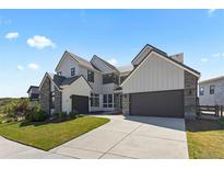 Stunning exterior of a modern farmhouse-style home with two-car garage and manicured lawn at 2230 Rim Ridge Dr, Castle Pines, CO 80108