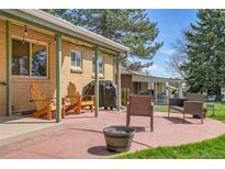 Inviting back patio with comfortable seating and a barbecue grill, perfect for outdoor entertaining at 12286 W Tennessee, Lakewood, CO 80228
