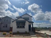 Charming two-story home boasts a modern design with black trim and a well-maintained landscaped yard at 2070 Wagon Wheel Aly, Brighton, CO 80601
