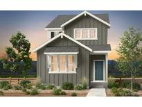 Charming home with gray siding, complemented by a well-maintained lawn and garden beds at 2070 Wagon Wheel Aly, Brighton, CO 80601