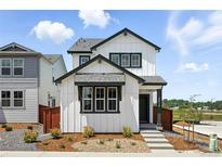 Charming two-story home features a modern white exterior with a landscaped front yard and welcoming entrance at 2070 Wagon Wheel Aly, Brighton, CO 80601
