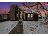Charming ranch home with wood siding and snow-covered yard at 245 Cedar St, Hudson, CO 80642