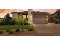 Charming single-Gathering home featuring a two-car garage, well-maintained lawn, and professional landscaping at 17358 W 95Th Ave, Arvada, CO 80007