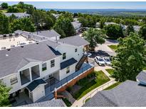 Exterior view featuring private balconies, manicured lawn, and parking at 1697 S Cole St # B5, Lakewood, CO 80228