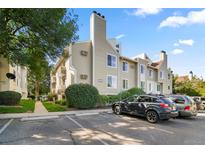 Exterior view of this lovely townhouse with well maintained landscaping and assigned parking at 4068 S Atchison Way # 103, Aurora, CO 80014