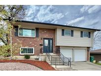 Inviting home with brick facade, freshly painted trim, and well-maintained landscaping at 8351 Ralphh Ln, Denver, CO 80221