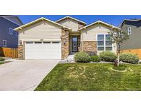 Charming home with a well-manicured lawn and beautiful stone accents on the facade at 6863 E 132Nd Pl, Thornton, CO 80602