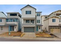 New construction home showing a modern elevation, blue door and landscaping at 8229 Butte Creek St, Littleton, CO 80125