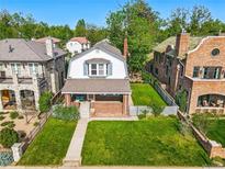 Charming two-story home features a well-manicured lawn and classic brick accents at 618 S Franklin St, Denver, CO 80209