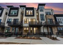 Stunning modern townhome exterior featuring private balconies and a stone and stucco facade at 2323 Lakeshore Ln # 11, Superior, CO 80027