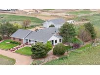 Wide angle view of home with large barn, meticulous landscaping, and ample land at 15020 Harrison St, Brighton, CO 80602