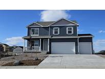 Charming two-story home featuring a three-car garage, landscaped yard, and a welcoming front porch at 3418 Belleville Ridge Rd, Elizabeth, CO 80107