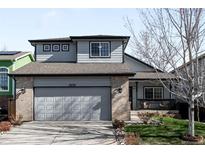 Charming two-story home with a manicured lawn and attached two-car garage at 10774 W 107Th Cir, Broomfield, CO 80021