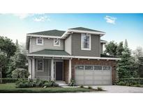 Charming two-story home with a brick accent and an attached two-car garage, surrounded by lush landscaping at 7387 S Yank Ct, Littleton, CO 80127