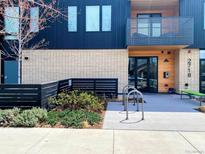 Modern apartment building featuring a clean design, balcony, bike racks, and landscaped surroundings at 2718 Pine St # 305, Boulder, CO 80302