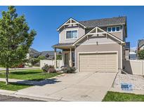 Charming two-story home featuring a two-car garage and a well-maintained lawn with beautiful landscaping at 4405 Walden Ct, Denver, CO 80249