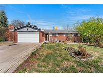 Charming single-story brick home with a well-maintained lawn, inviting curb appeal, and a two car garage at 3002 S Fenton St, Denver, CO 80227