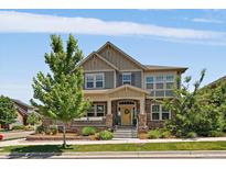 Charming two-story home with a covered front porch, stone accents, and manicured landscaping at 5663 W 96Th Ave, Westminster, CO 80020