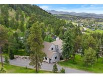 Stunning exterior of a home nestled in a lush, mountainous landscape at 1129 Genesee Vista Rd, Golden, CO 80401