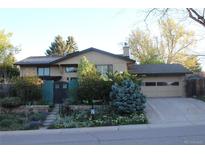 Charming two-story home with lush landscaping and a private front entrance, complemented by an attached two-car garage at 8095 E Lehigh Ave, Denver, CO 80237
