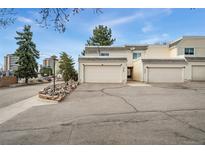 A charming townhouse featuring two single-car garages, a landscaped front, and a well-maintained exterior at 2960 S Parker Ct, Aurora, CO 80014