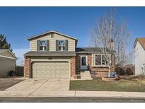 Charming two-story home featuring a brick facade, two-car garage, and well-maintained lawn at 8370 Sandreed Cir, Parker, CO 80134