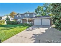 Charming two-story home featuring a well-manicured lawn and a spacious two-car garage at 3270 S Krameria St, Denver, CO 80222