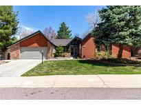 Charming single-Gathering home with a well-manicured lawn and mature landscaping at 7778 S Cherry Ct, Centennial, CO 80122